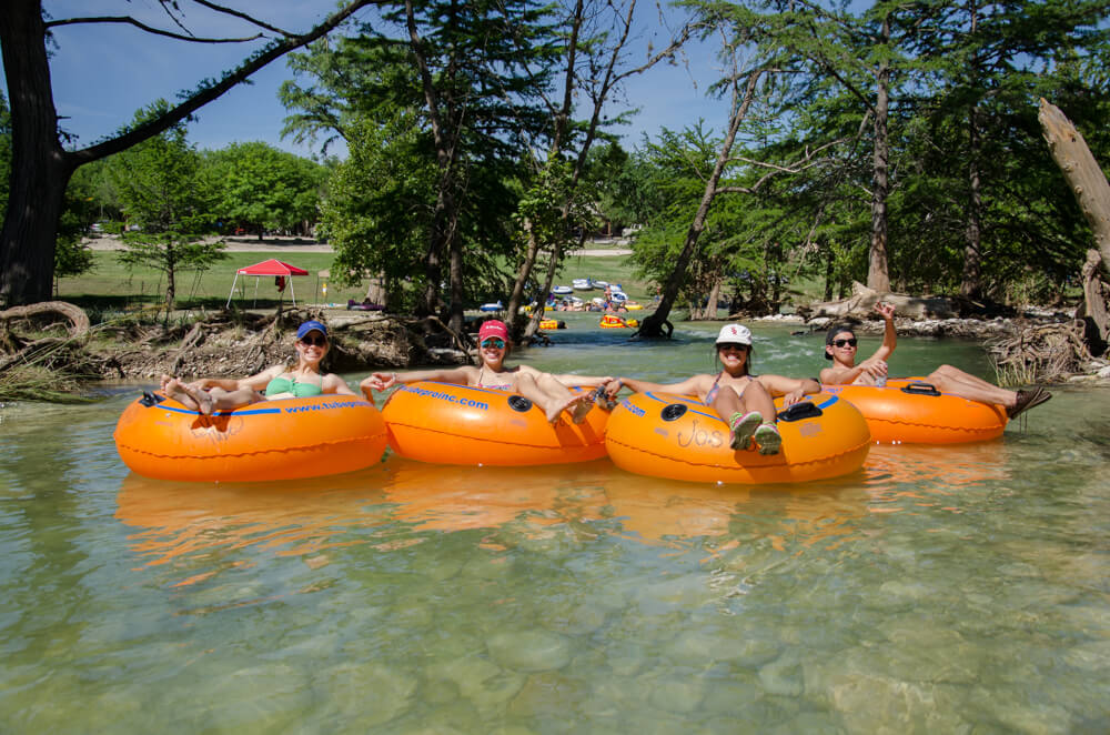 A group of people enjoying their summer vacation to the Frio River